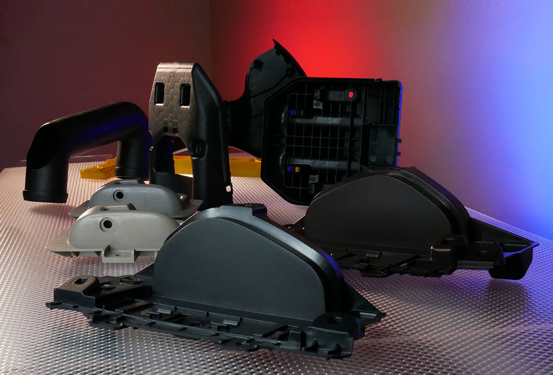 Automotive-grade injection molded plastic components including housings, ducts, and covers designed for durability and precision fit.