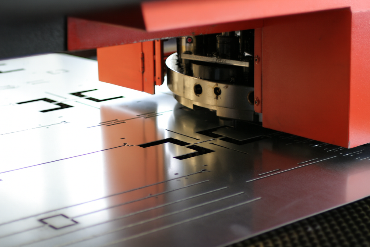 CNC turret punching sheet metal for custom fabrication.