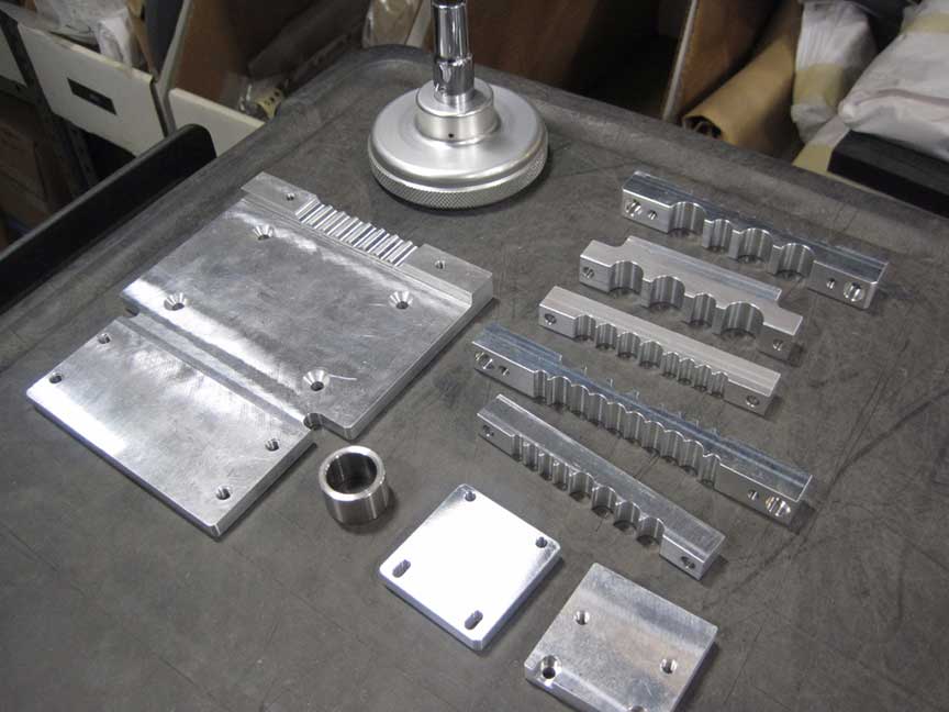 CNC machined aluminum components with raster-cut profiles and fixture-ready parts.