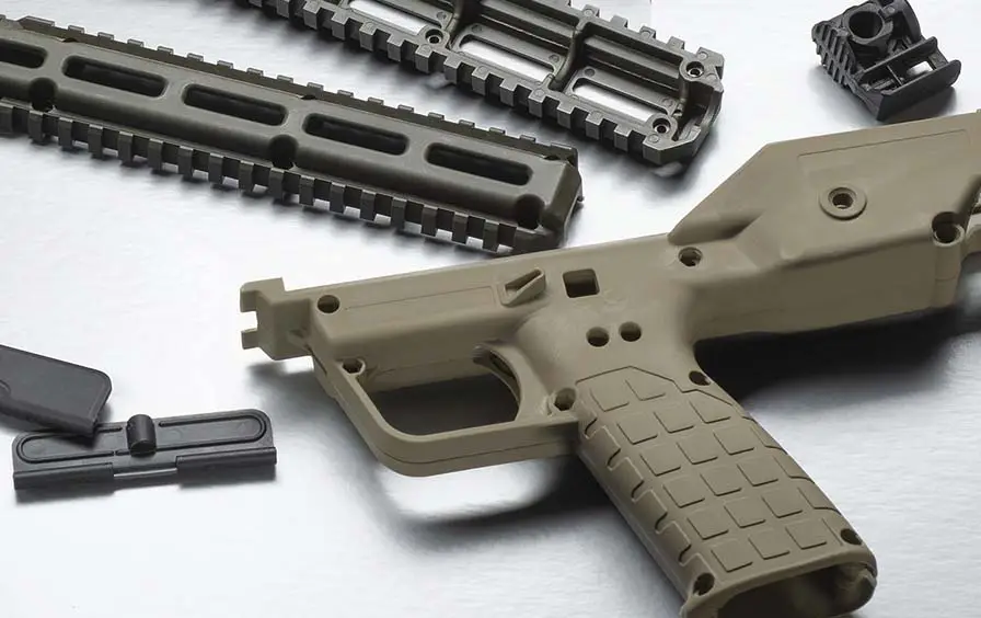 FFL plastic injection molding of polymer firearm components (lower receiver, handguard rails, and small parts) with FDE color matching.