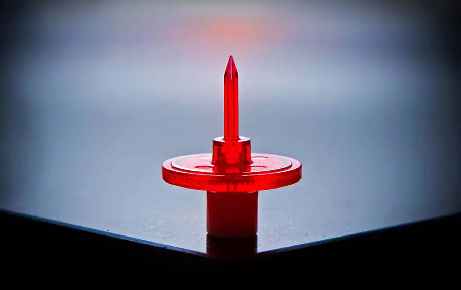 Tight-tolerance injection-molded spike or vent component with crisp micro-features, sharp edges, and a high-gloss finish.